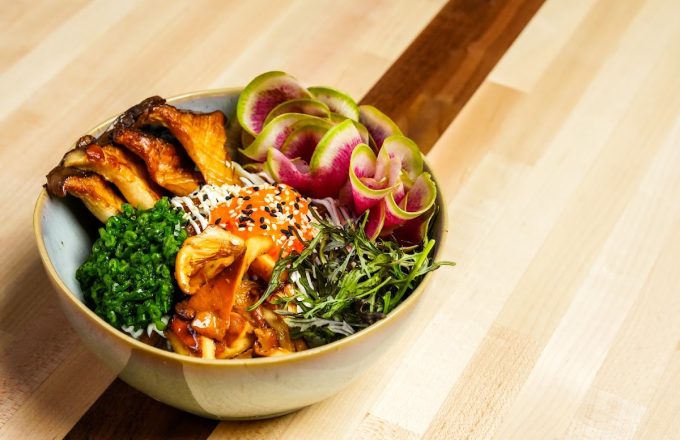 Grain bowl with glazed protein, watermelon radish ribbons, seaweed salad, and sesame seeds at Barbacana