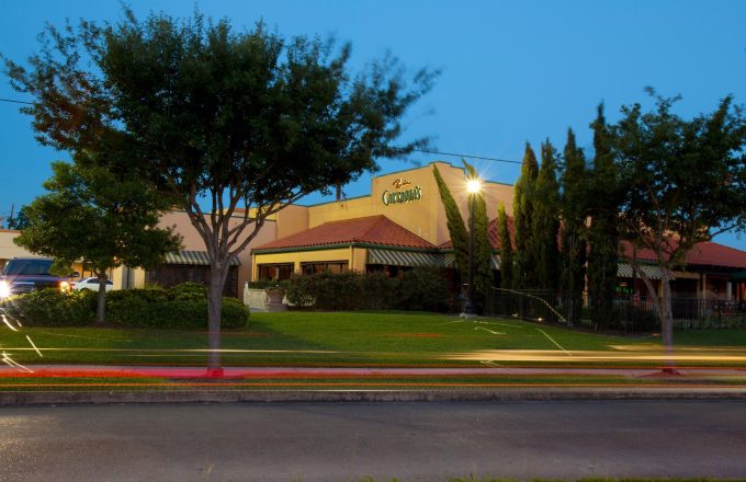 Carrabba's The Original on Voss restaurant exterior at twilight with illuminated sign and street light trails on South Voss Road in Houston