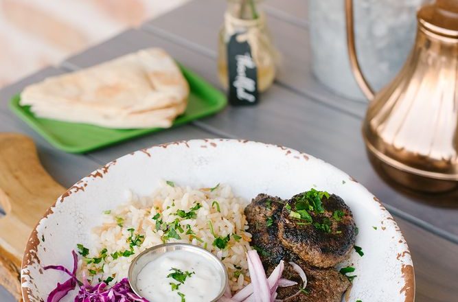 Beef shawarma rice bowl with toppings and sauces at Craft Pita — Fountain View