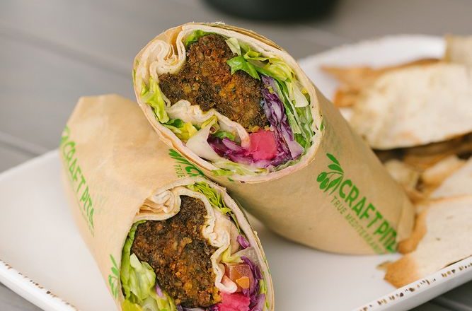 Falafel pita wrap stuffed with vegetables and tahini sauce at Craft Pita — Fountain View