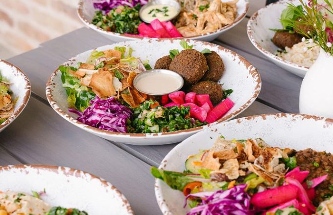 Interior dining area with colorful fresh salad bar and modern seating at Craft Pita — Fountain View