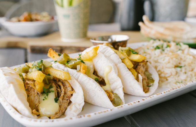 Lebanese tacos with assorted toppings and fresh garnish on a plate at Craft Pita — Fountain View