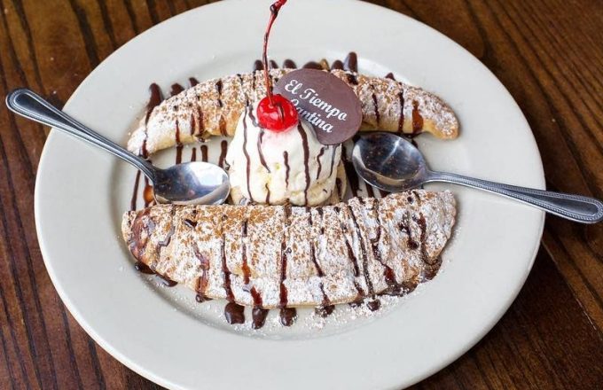 Signature chocolate dessert with cherry and branded chocolate logo at El Tiempo Cantina