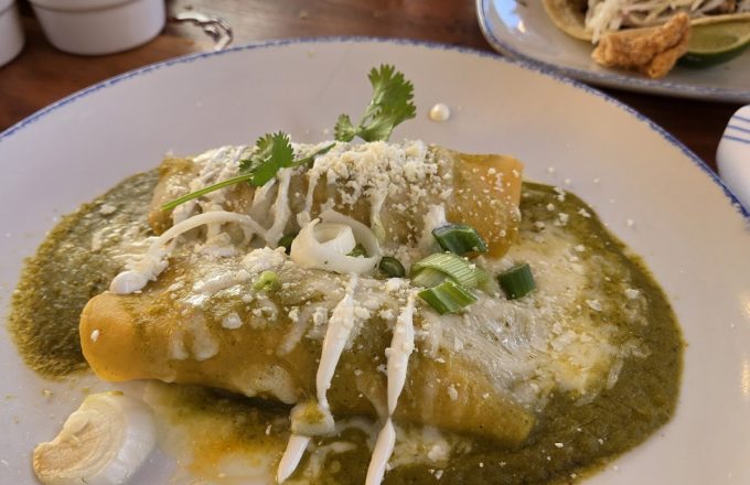 Enchiladas verdes topped with tomatillo sauce, crema, queso fresco, and fresh cilantro at Ninfa's on Navigation