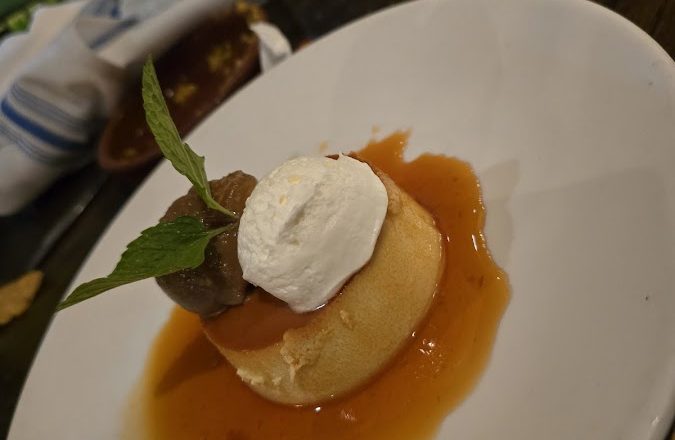 Flan with caramel sauce and whipped cream garnished with mint at Rio Grande Tex-Mex Grill