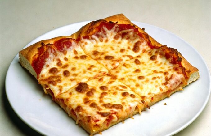 The legendary Friday square pizza — a geometric triumph of the American school kitchen, delivered piping hot onto a ten-inch white plastic plate.