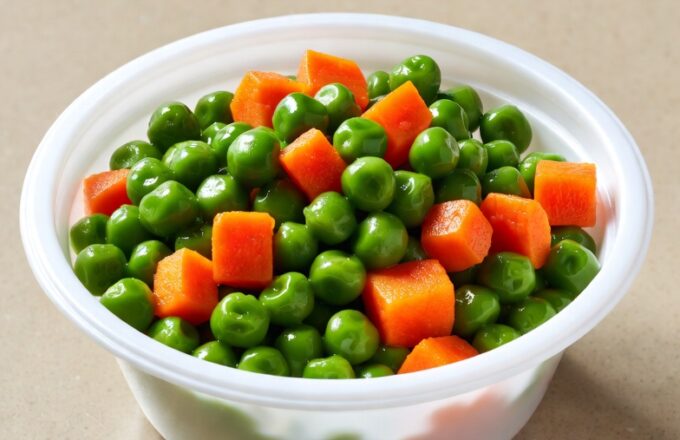 Peas and carrots, the eternal cafeteria side dish — steamed to submission and served without apology.