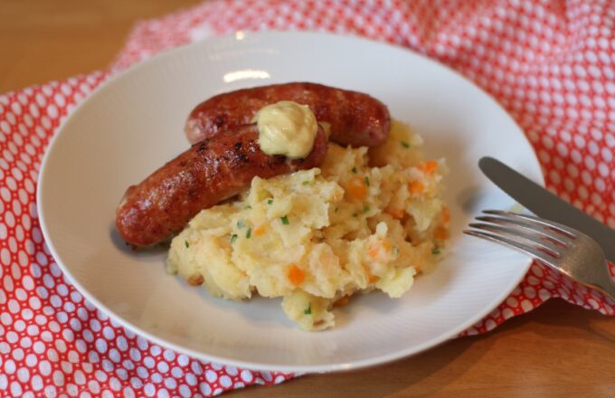 Two whole sausages, as the good Lord and Sysco intended, flanked by a modest heap of something green-adjacent.